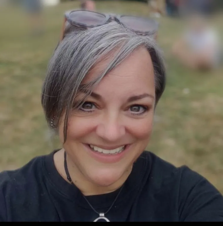 Author K. M. Pritchard, smiling outdoors.